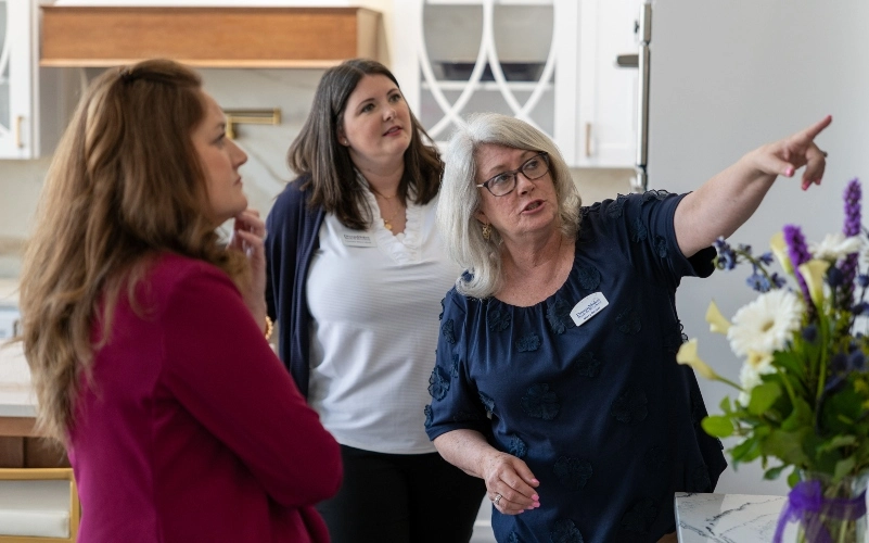 "DreamMaker franchise owner showing clients design options"